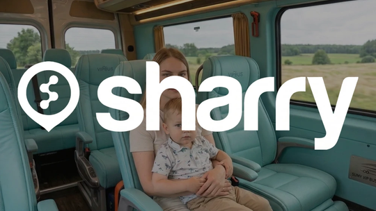 Sharry na tle mamy z dzieckiem siedzące w skórzanym wnętrzu minibusa